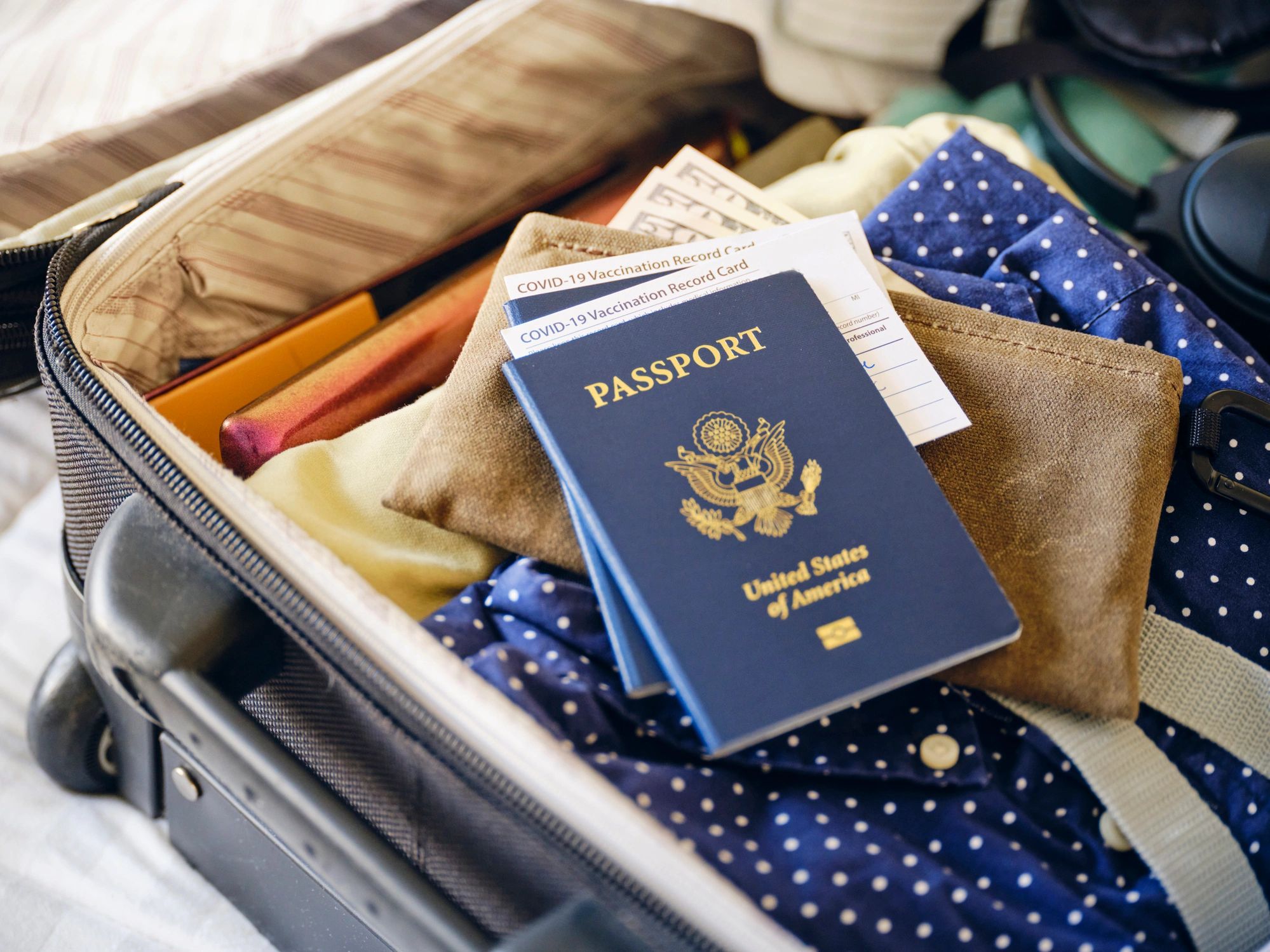 Suitcase and passport prepared for travel
