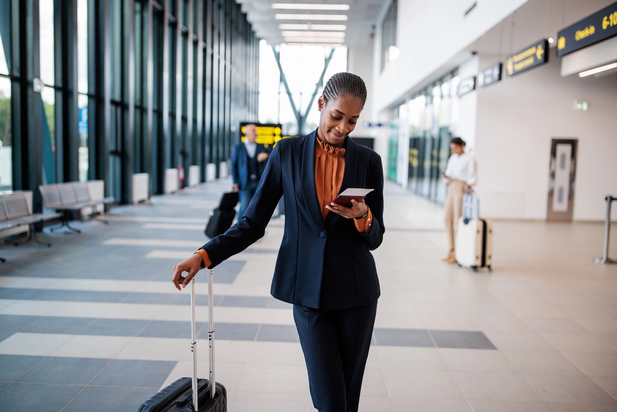 Client in an airport terminal holding a passport
